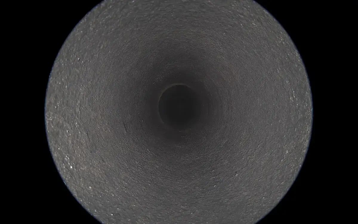 Clean cast-iron pipe after hydro jetting — mineral scale fully removed, Warren MI