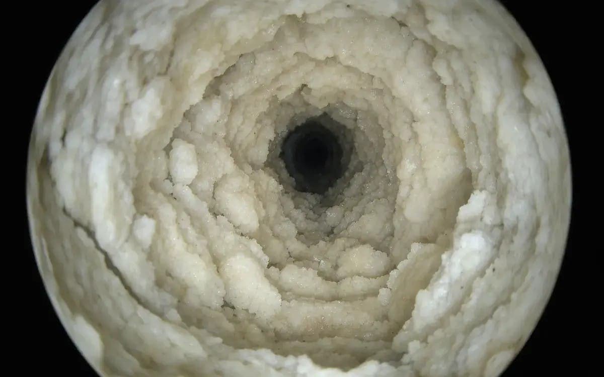 Calcium and magnesium mineral scale in cast-iron bathroom drain — Warren, MI