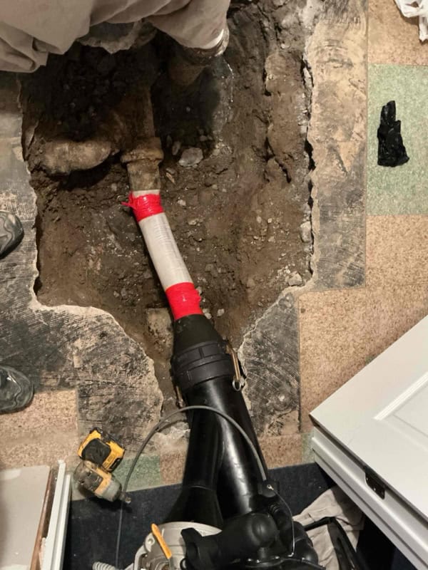 CIPP liner feeding through the inversion elbow into the sewer line access point during no-dig sewer repair in Sterling Heights, MI