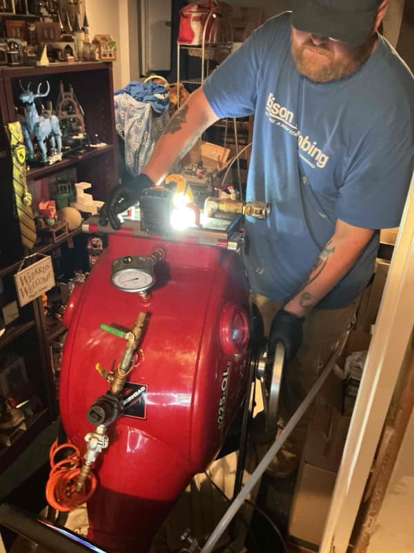 Bison Plumbing technician operating the CIPP inversion unit during no-dig sewer line repair, Sterling Heights MI