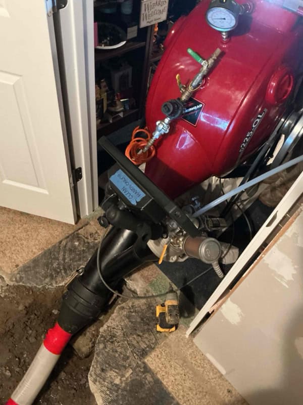 CIPP inversion drum with pressure gauge installing cured-in-place pipe liner through interior access, Sterling Heights MI